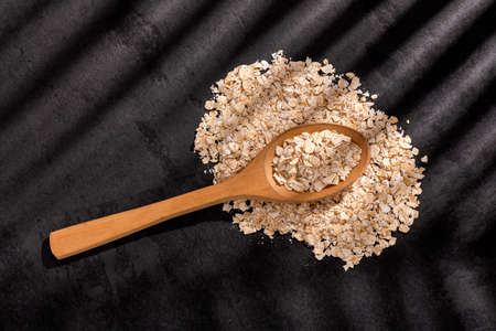 Oat flakes in the wooden spoon - Avena sativa