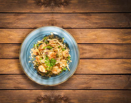 Delicious fettuccine pasta with shrimp and parsley - wooden backgroundの写真素材