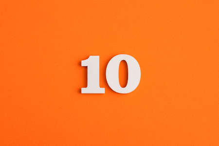 White wooden number 10 on eva rubber orange backgroundの写真素材
