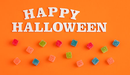 word halloween in white wooden letters - sweet jelly candiesの写真素材