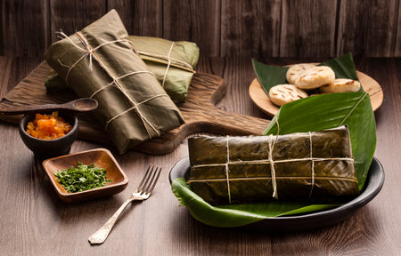 Steamed tamale wrapped in banana leaves - Traditional Colombian Gastronomyの写真素材