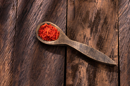 Dehydrated dried tomato flakes in the spoon - Solanum lycopersicumの写真素材