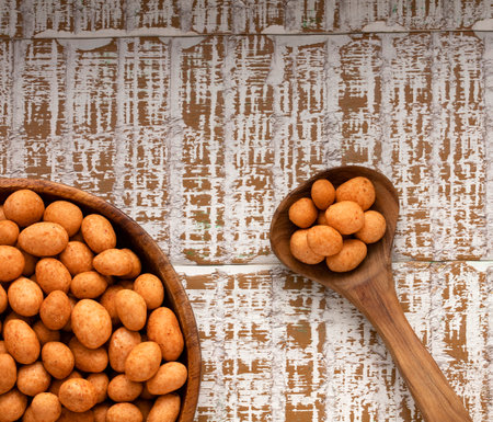 Organic Mexican fried peanuts in spoon and bowl - Arachis hypogaeaの写真素材