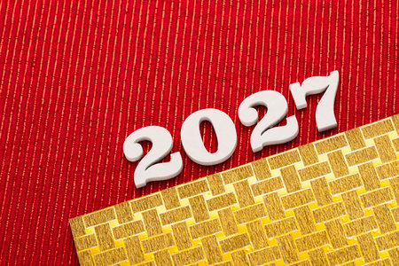 Happy new year 2027 - White wooden letters on red background