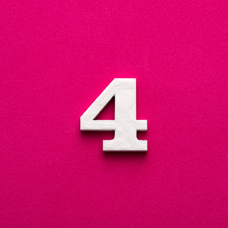 Number 4 - White wooden number on rhodamine red backgroundの写真素材