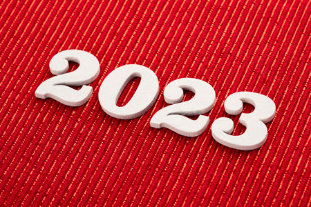 Happy new year 2023 - White wooden letters on red background