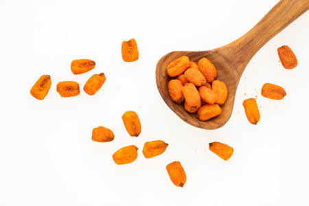 Crunchy salty chili corn - Zea mays. Toasted snacks on the spoon