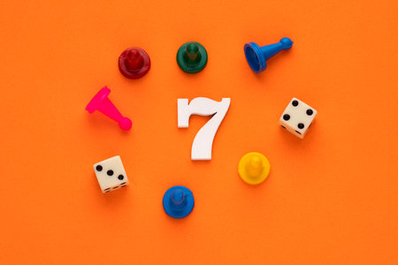 Number seven in white with pieces and gambling dice - Orange eva rubber background