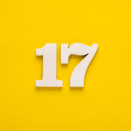 Number 17 - Two figures in white on a yellow backgroundの写真素材