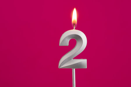 Candle number 2 - Birthday in rhodamine red backgroundの写真素材