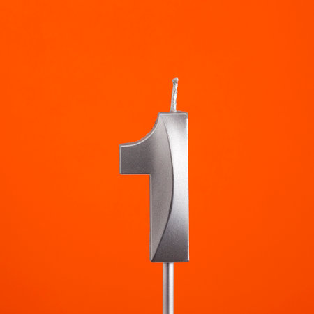 Number 1 candle - Birthday in orange backgroundの写真素材