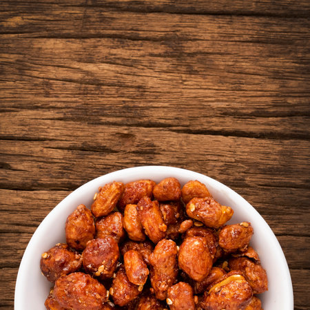 Roasted peanut with caramel coating and white sesame seeds - Arachis hypogaeaの写真素材