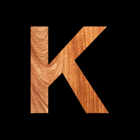 Capital letter K on oak wood background - Black backgroundの写真素材