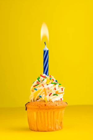 Number 1 candle - Birthday cake on yellow background.の写真素材
