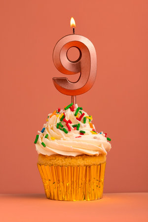 Birthday cake with candle number 9 - Coral fusion backgroundの写真素材