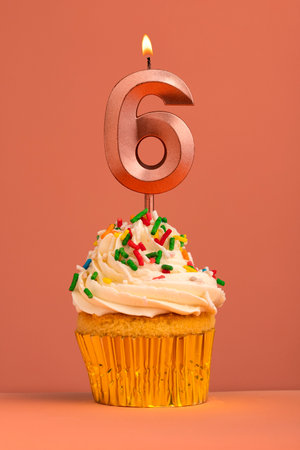 Candle number 6 - Cake birthday in coral fusion backgroundの写真素材