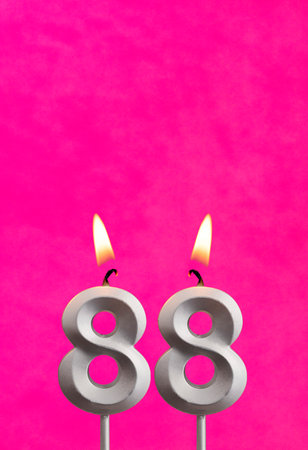 Candle 88 with flame - Birthday card in fuchsia backgroundの写真素材