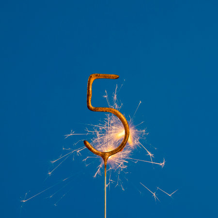 Birthday number 5 of sparks on blue backgroundの写真素材