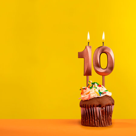 Number 10 birthday candle - Celebration on yellow backgroundの写真素材