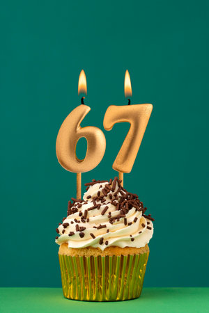 Birthday candle number 67 - Vertical anniversary card with green backgroundの写真素材