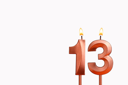 Birthday candle number 13 on white backgroundの写真素材