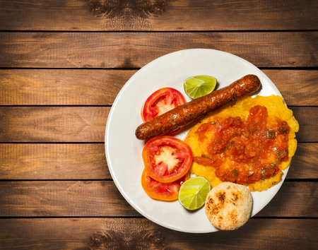 Fried chorizo with patacon and tomatoes - Colombian traditional foodの写真素材