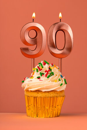 Candle number 90 - Cake birthday in coral fusion backgroundの写真素材