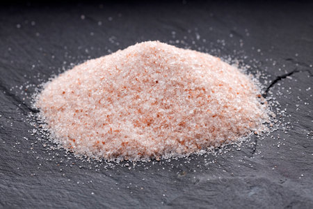 Fine grains of pink Himalayan salt, powder red rock salt from Pakistanの写真素材