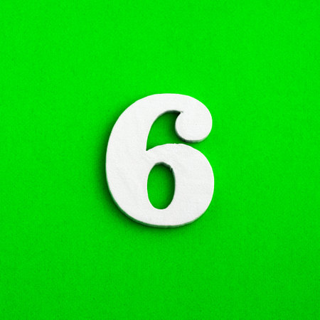 Number 6 - White wooden number on green backgroundの写真素材