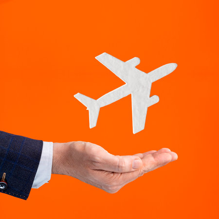 Businessman hand holding airplane icon - Air ticket insurance policyの写真素材