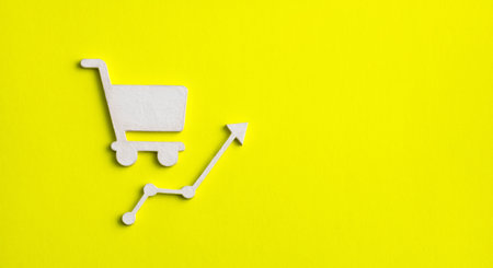 Food value increase concept - supermarket cart with arrow on yellow backgroundの写真素材