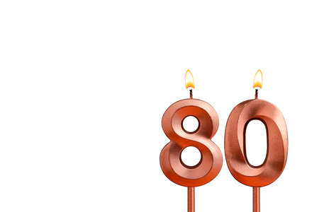 Burning candle number 80 for birthday on white backgroundの写真素材