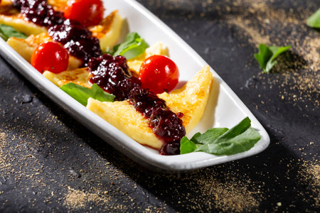 Grilled papialpa cheese with red fruit jam with cherry tomatoes and basilの写真素材