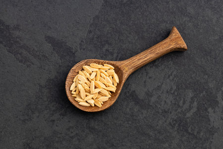 Dry orzo pasta on spoon - Italian risoni in the form of rice grainsの写真素材