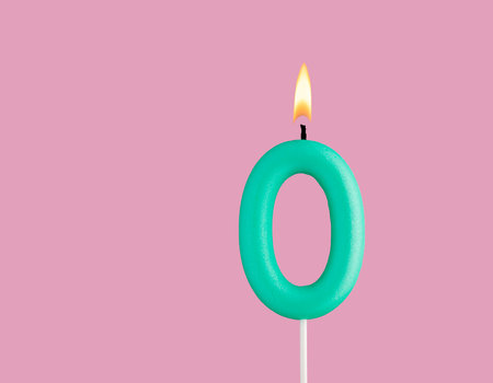 Green candle number 0 - Birthday card on pastel pink backgroundの写真素材