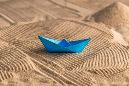 Sand dune with blue paper boat - Art for decorationの写真素材