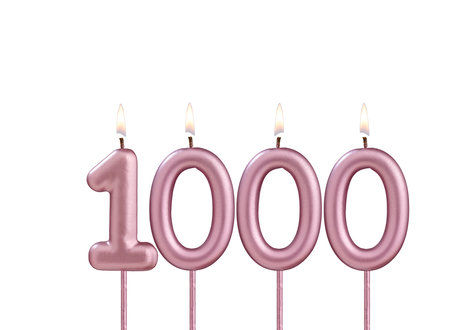 Candle number 1000 - Lit birthday candle on white backgroundの写真素材