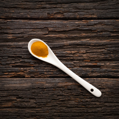 Natural turmeric spice on spoon - Curcuma longaの写真素材