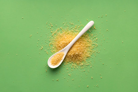 Yellow japanese panko crumbs on white spoon
