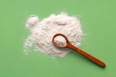 Baking Soda - Crystalline Solid compound in spoon. green backgroundの写真素材
