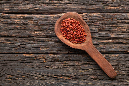Bixa Orellana - Organic red annatto seeds in a spoonの写真素材