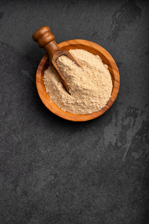 Organic Peruvian maca powder in the bowl and spoon - Lepidium meyeniiの写真素材