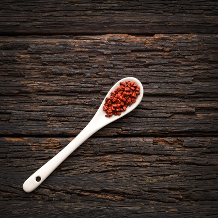 Organic red annatto seeds in the spoon - Bixa Orellanaの写真素材
