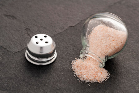 Pink Himalayan salt - Fine crystals in a glass salt shaker.