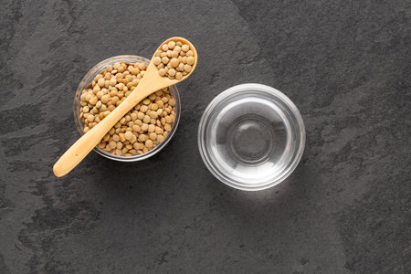 Lens culinaris - Brown lentils and water in the bowl.の写真素材