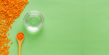 Red lentils and water in the bowl - Lens culinaris.