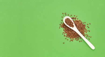 Organic Linum usitatissimum seeds on spoon - Flax seeds, healthy food.