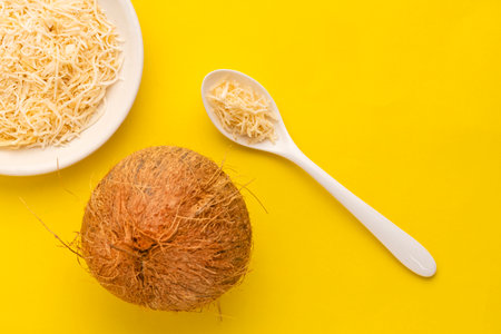 Cocos nucifera - Fresh grated coconut in the bowl and spoon.の写真素材