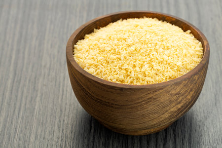 Bread crumbs or yellow panko in the wooden bowl.の写真素材
