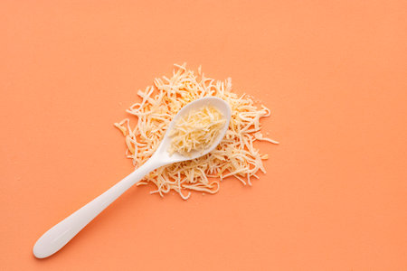 Dehydrated coconut flakes with sugar - Cocos nucifera on the spoon.の写真素材